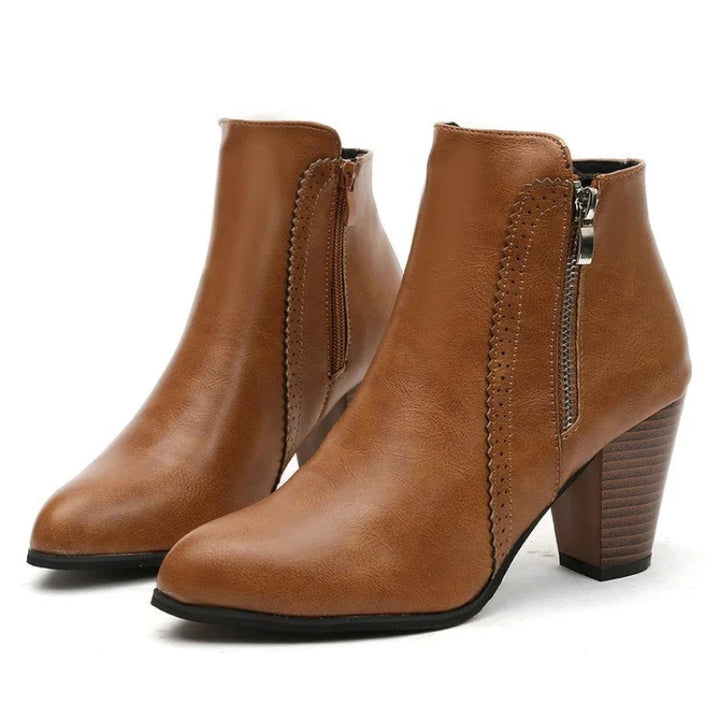 Elegant women's zip ankle boots, showcasing a distinctive scalloped edge and comfortable design for all occasions.