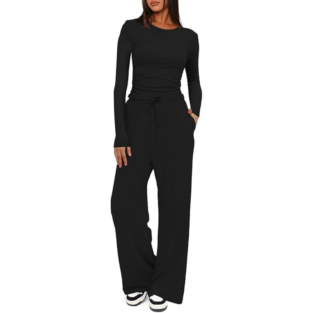 Woman sitting comfortably in a two-piece lounge set, Lieke, with long sleeve top and wide leg pants