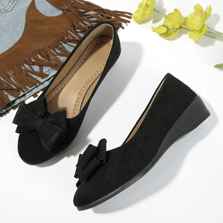 Blue casual women's ballet flats, wedge design, slip-on convenience, and cute bow detail.