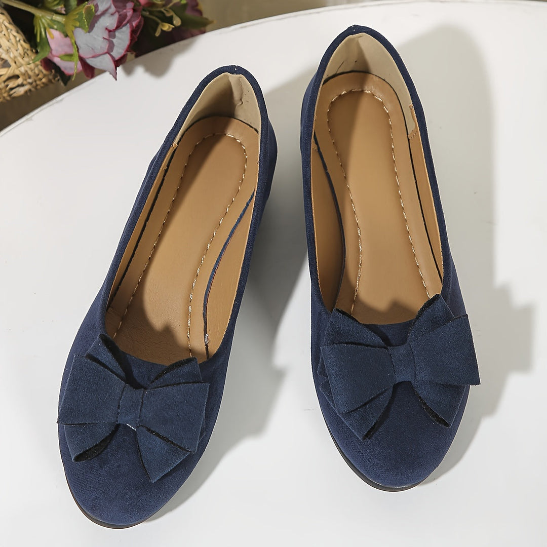 Blue versatile women's flats, wedge style, bow accent, and easy slip-on fit.