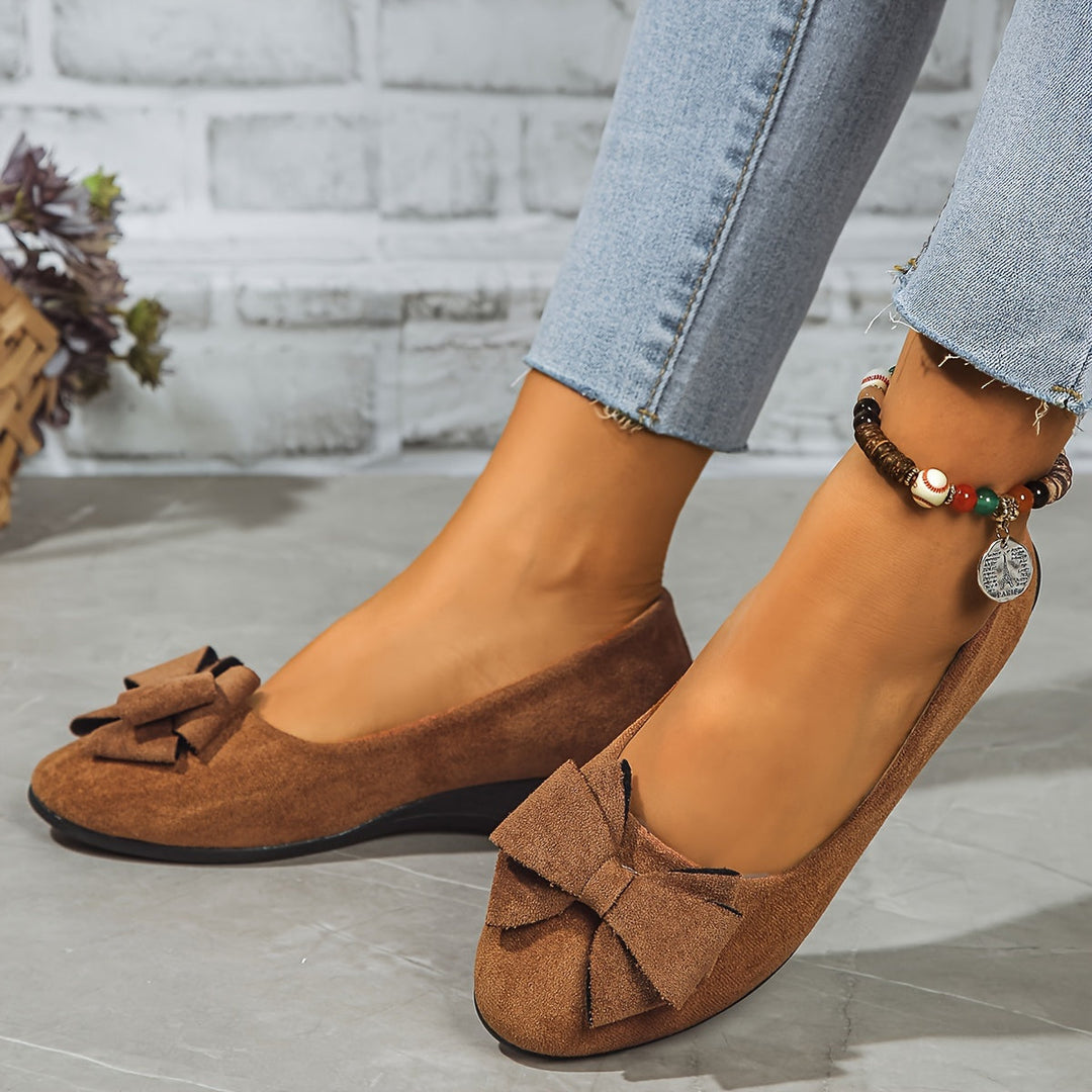 Women's black round toe slip-on wedge flats, ballet style, with a decorative bow.