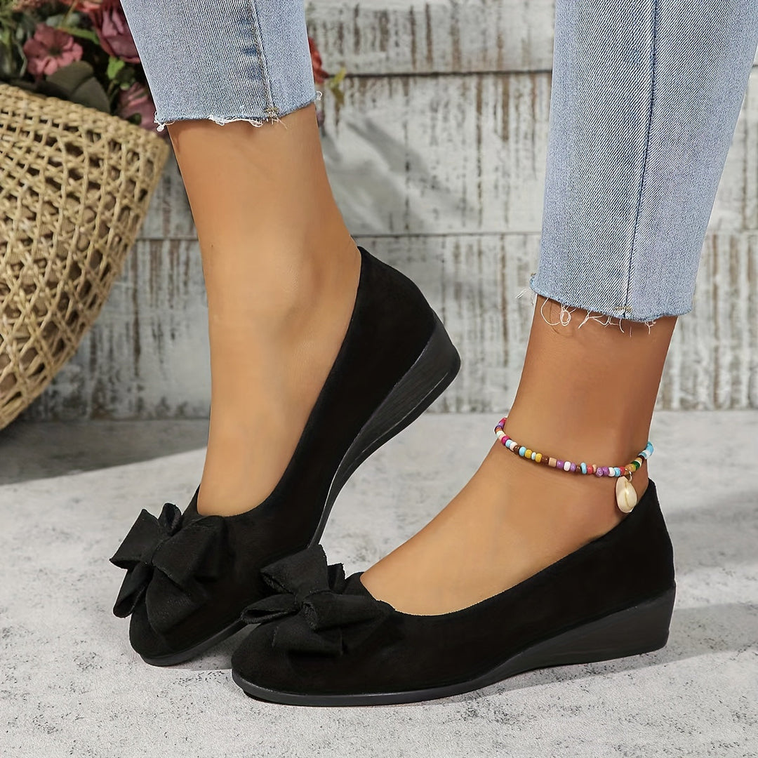 Stylish blue slip-on wedge ballet flats for women with a delicate bow and comfortable round toe.