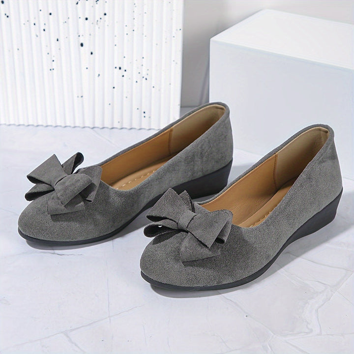 Blue women's comfortable wedge flats, slip-on ballet style, featuring a delicate bow.