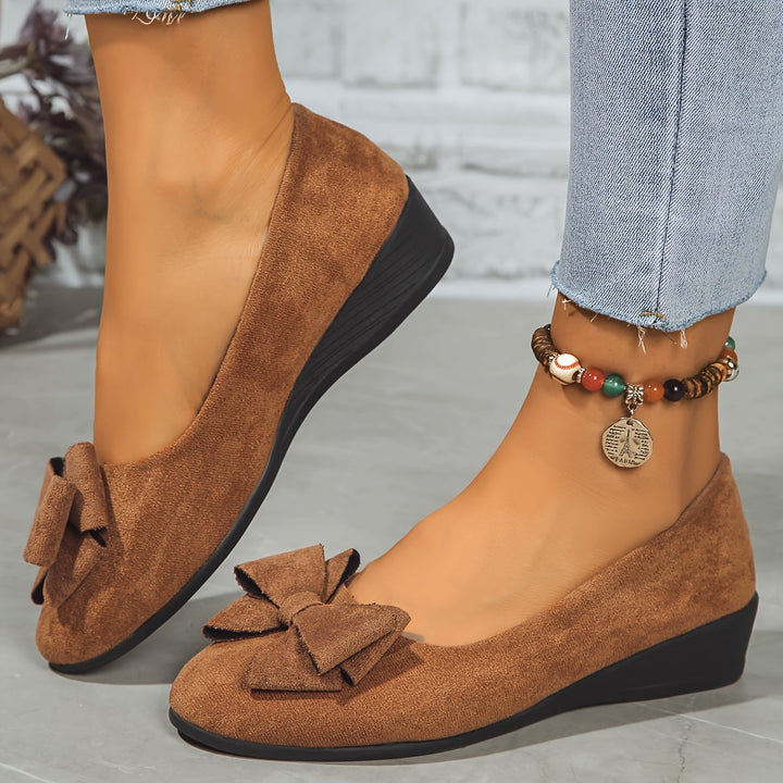 Everyday gray women's slip-on ballet flats with a subtle wedge, bow, and round toe.