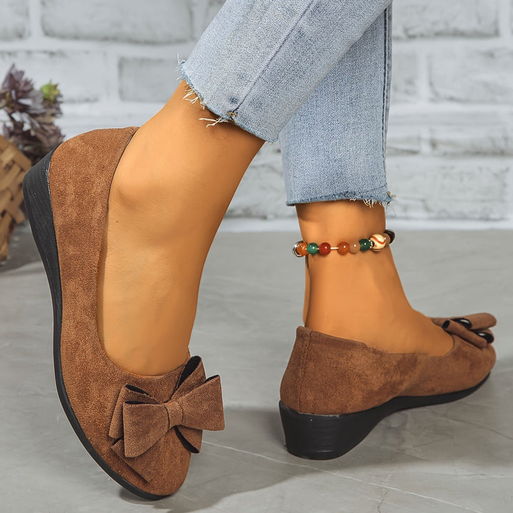 Women's black round toe wedge ballet flats with charming bow detail for all-day comfort.