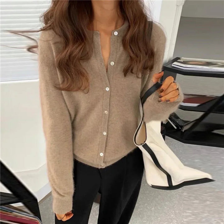 Comfortable women's knitted top with button details, great for layering in fall and winter seasons.