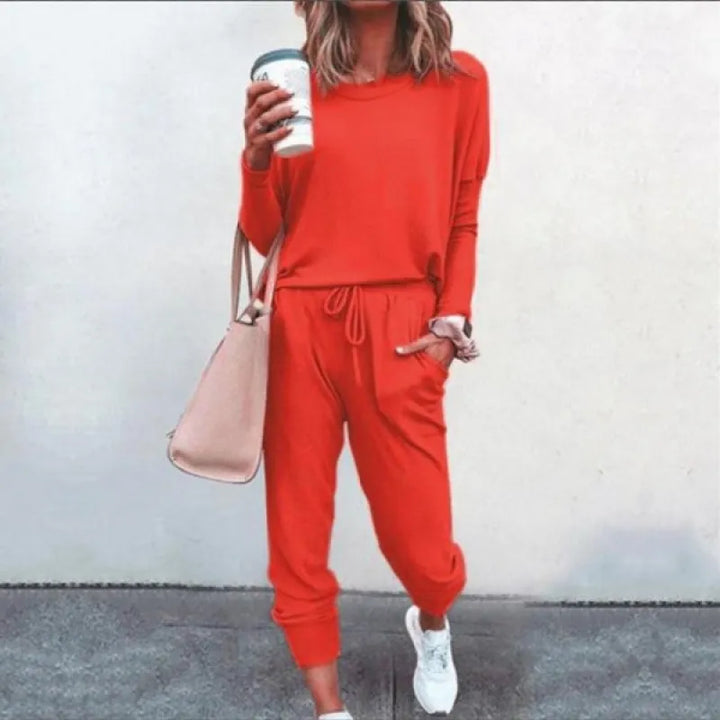 Two-piece women's jogger set with long sleeve crew neck top & tapered pants, ideal for activewear or casual comfort.