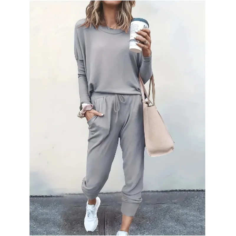Woman wearing a comfortable crew neck jogger set, showcasing the long sleeve top and tapered pants for loungewear.
