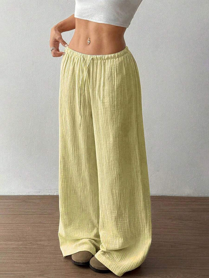 Casual women's crinkle wide leg pants with drawstring, perfect for summer comfort and stylish flair.