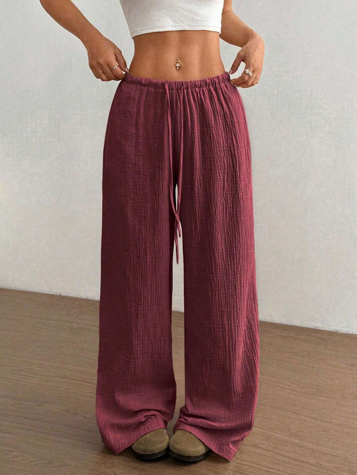 Stylish crinkle texture wide leg pants with drawstring, ideal for casual bohemian summer outfits.