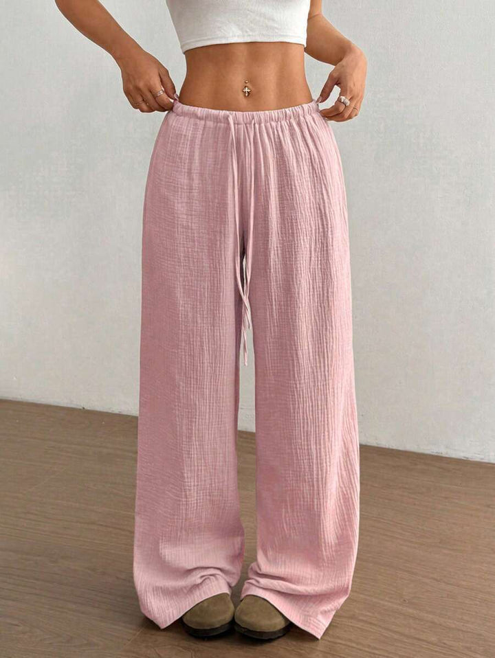 Relaxed fit women's crinkle textured wide leg pants with elastic drawstring for ultimate comfort.