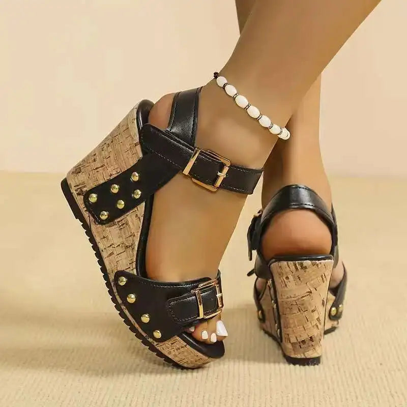 White comfortable women's sandals featuring a supportive cork wedge and double buckles. Stylish summer footwear.