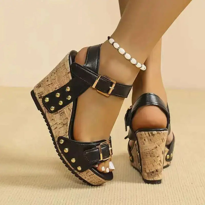 White comfortable women's sandals featuring a supportive cork wedge and double buckles. Stylish summer footwear.