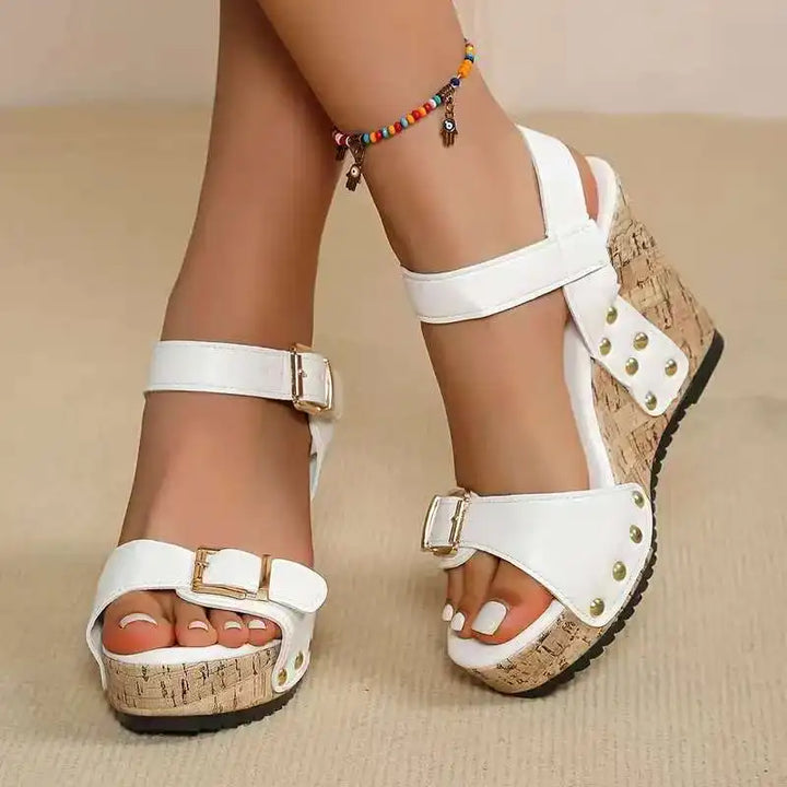Stylish black cork wedge sandals for women. Double buckle design provides comfortable, supportive, chic summer footwear.