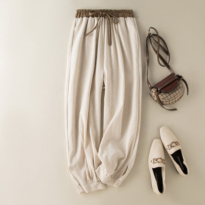 Beige tapered harem pants for women, featuring a comfortable relaxed fit and stylish cuffed hem.