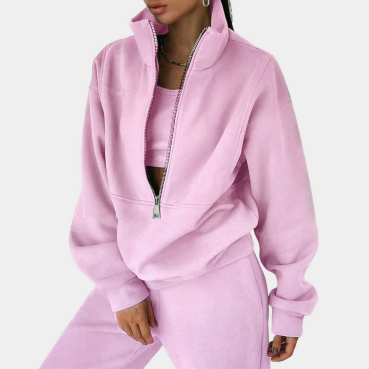 Front view of a women's comfortable pink jogging suit set, featuring a stylish two-piece design & relaxed fit.