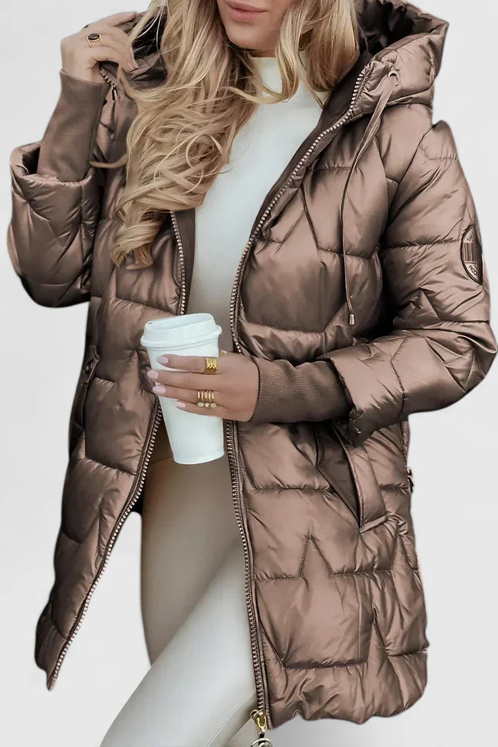 Elegant women's hooded winter coat. Padded, warm, and comfortable outerwear for autumn fashion.
