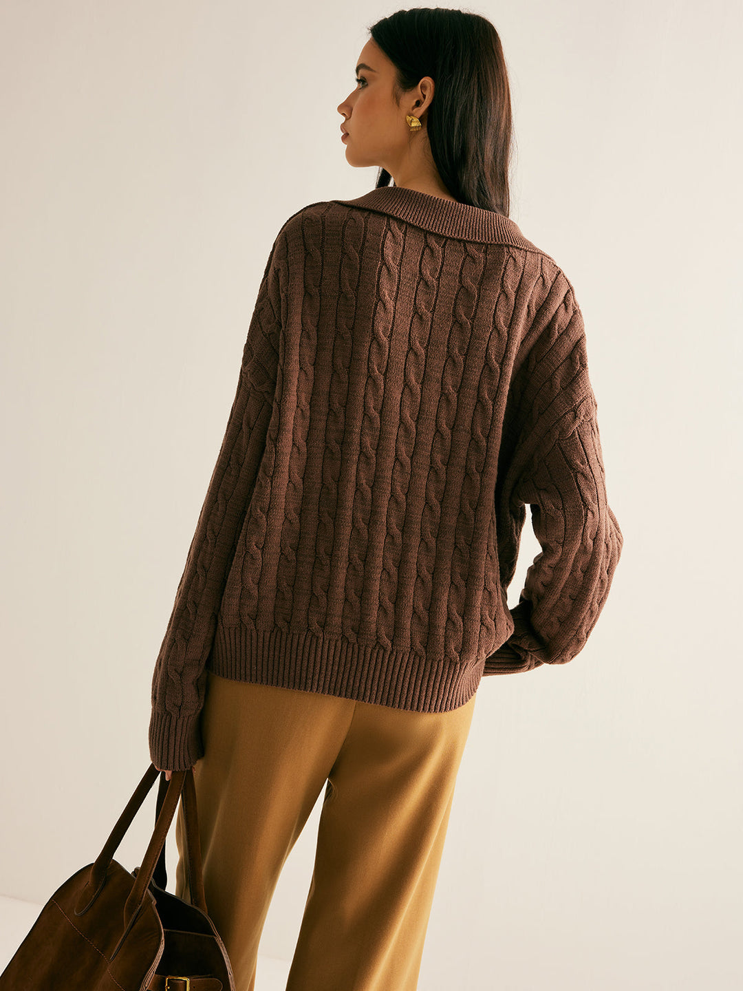Stylish women's brown V-neck knit sweater. Comfortable long sleeve jumper, versatile for casual or layered outfits.
