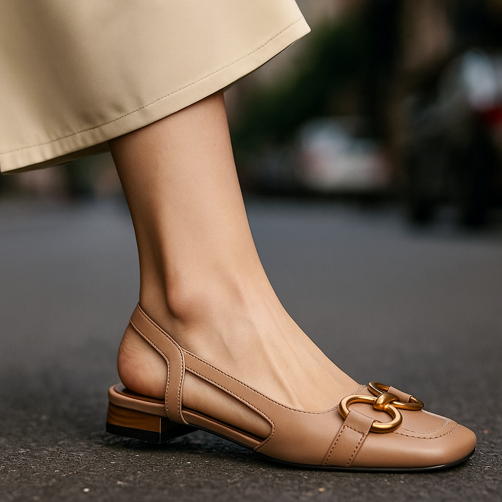 Close-up of the elegant gold chain detail on women's fashionable slingback flats, enhancing chic design.