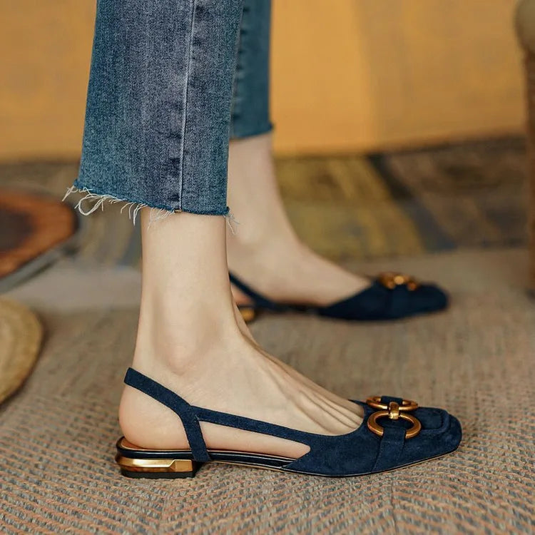 Model walking in versatile women's slingback flats, showcasing their comfort & elegant chain detail.