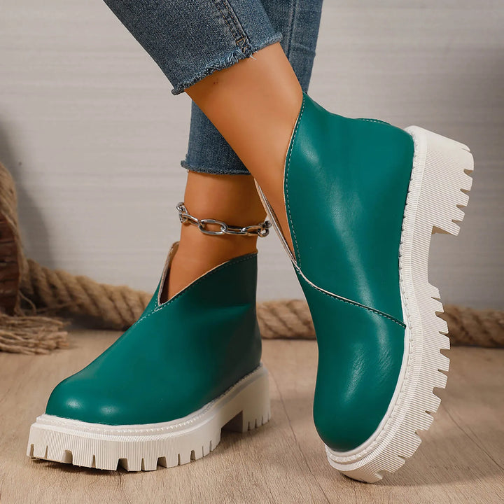 Close-up of comfortable women's leather platform slip-on sandals, showing quality craftsmanship & style.