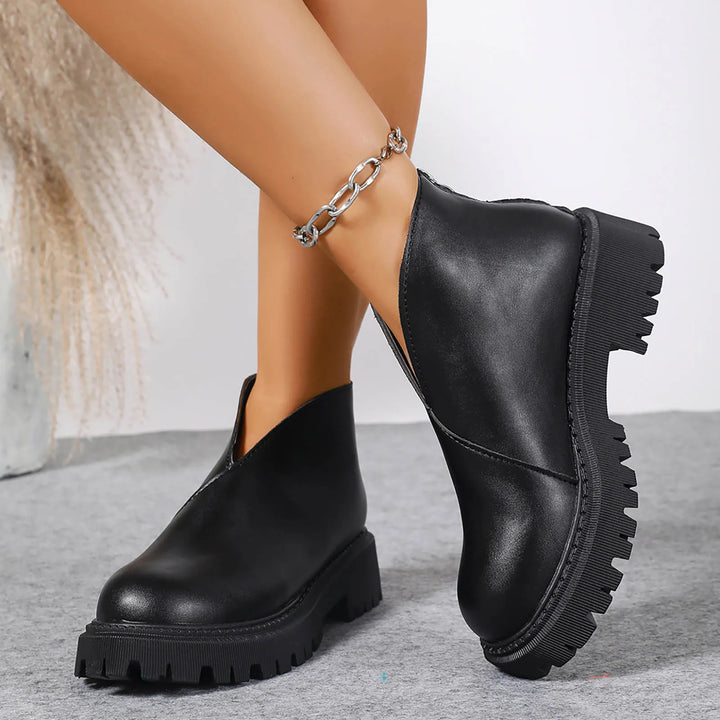 Pair of women's comfortable leather platform slip-on sandals, versatile casual footwear for any day.