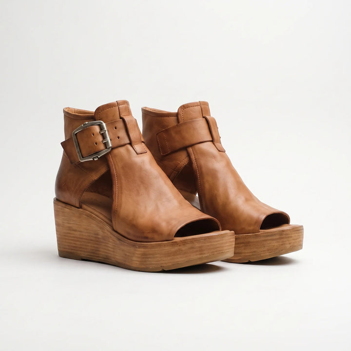 Vintage-inspired women's wedge sandals with platform heel & ankle strap. Stylish & comfortable for summer fashion.