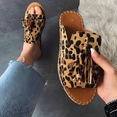 Leopard print women's woven cushioned slides, stylish slip-on sandals ideal for beach or everyday comfort.