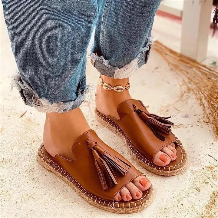 Stylish brown woven women's slides with a cushioned sole, perfect comfortable footwear for summer and casual outings.