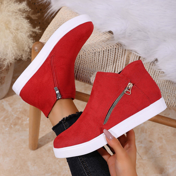 Close-up of women's comfortable zip sneakers, showing the easy closure & supportive orthopedic sole.