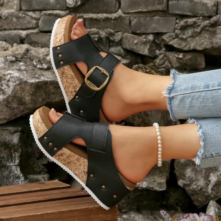 Women's slip-on buckle slides with comfortable cork sole and orthopedic support for summer casual wear.