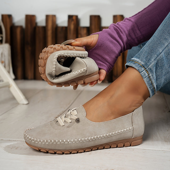 Woman's foot comfortably in slip-on shoe, showcasing arch support & design for sensitive feet & pain relief.