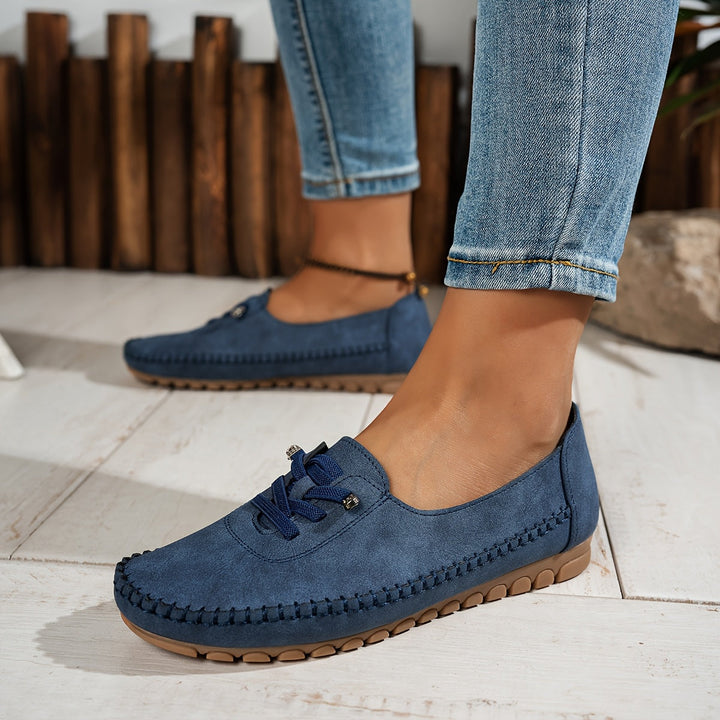 Woman walking outdoors in stylish slip-on comfort shoes, designed with arch support for sensitive feet.