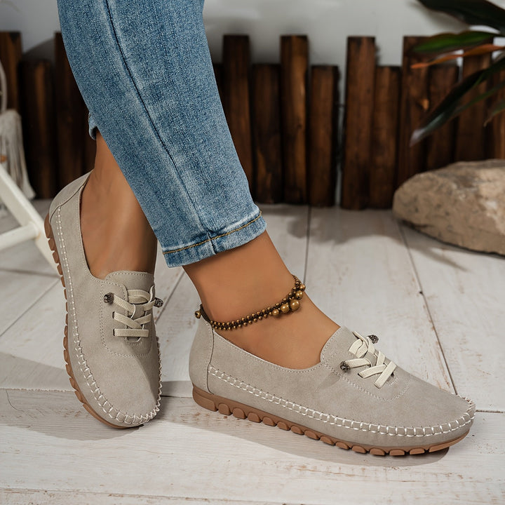 Front view: Women's comfort slip-on shoes, showcasing sleek design with arch support for sensitive feet.