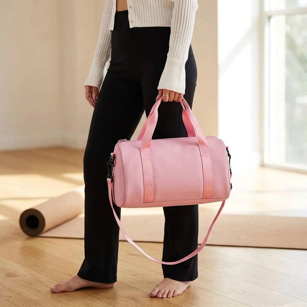 Women's compact gym duffel bag, lightweight & water-resistant for workouts and travel.
