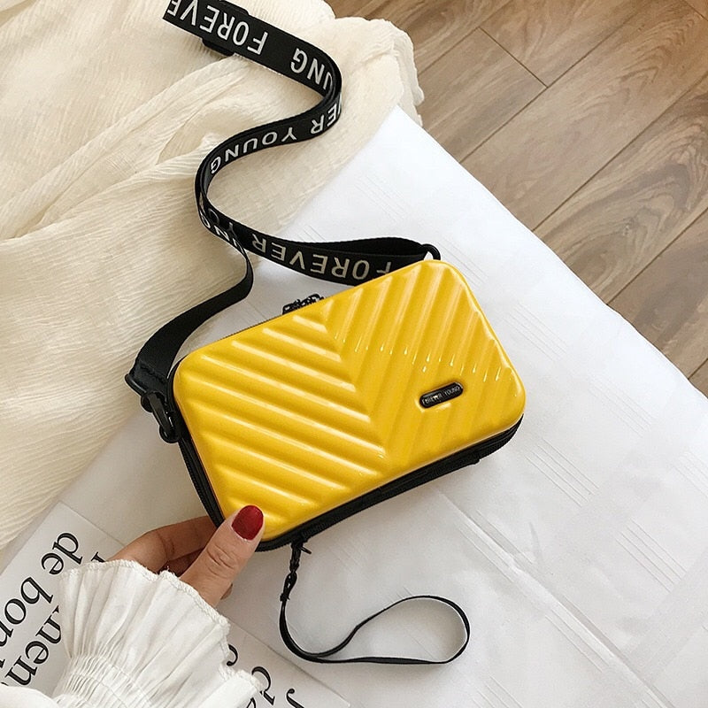 Women's compact hard shell crossbody bag with smooth zipper & adjustable strap. Vegan leather travel.