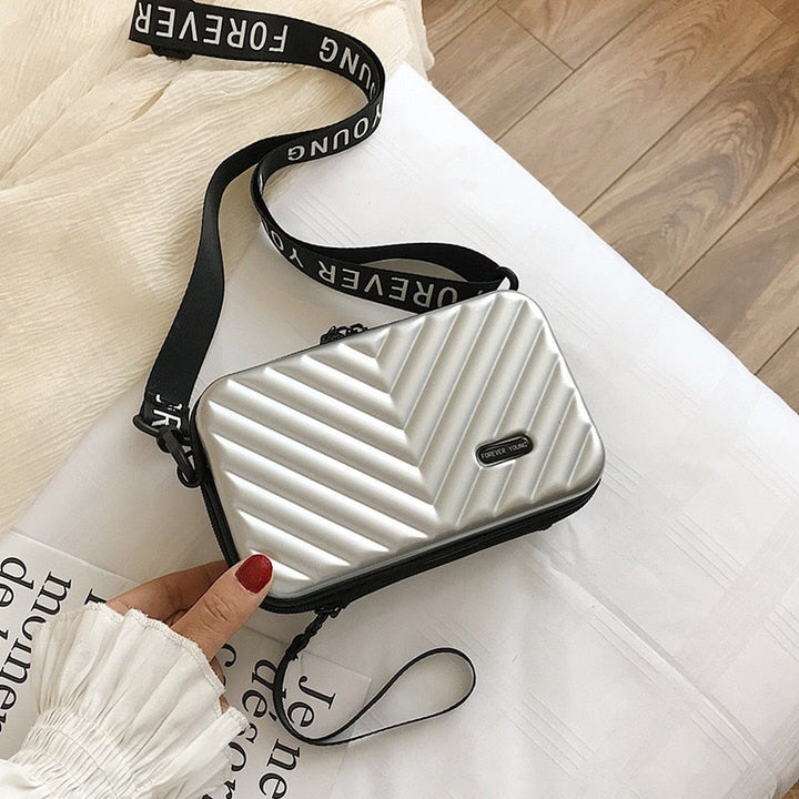 Durable vegan leather hard shell travel handbag for women. Secure zipper closure for essentials.