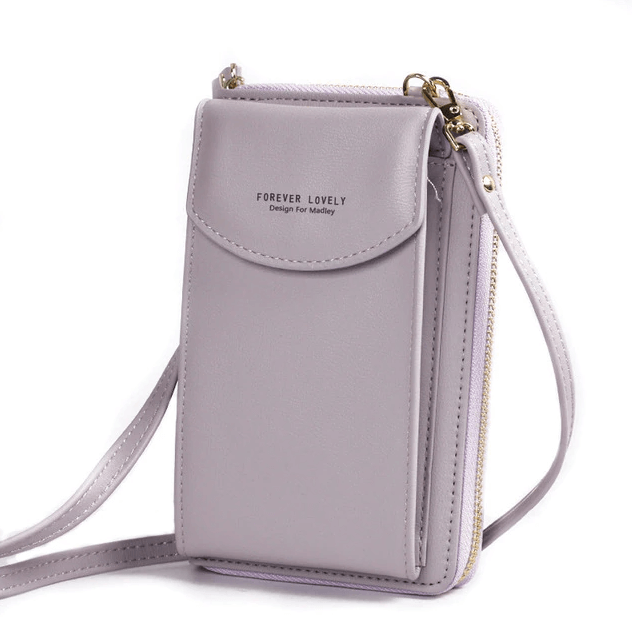 Close-up of a women's compact PU leather shoulder bag in brown, showing texture & stitching