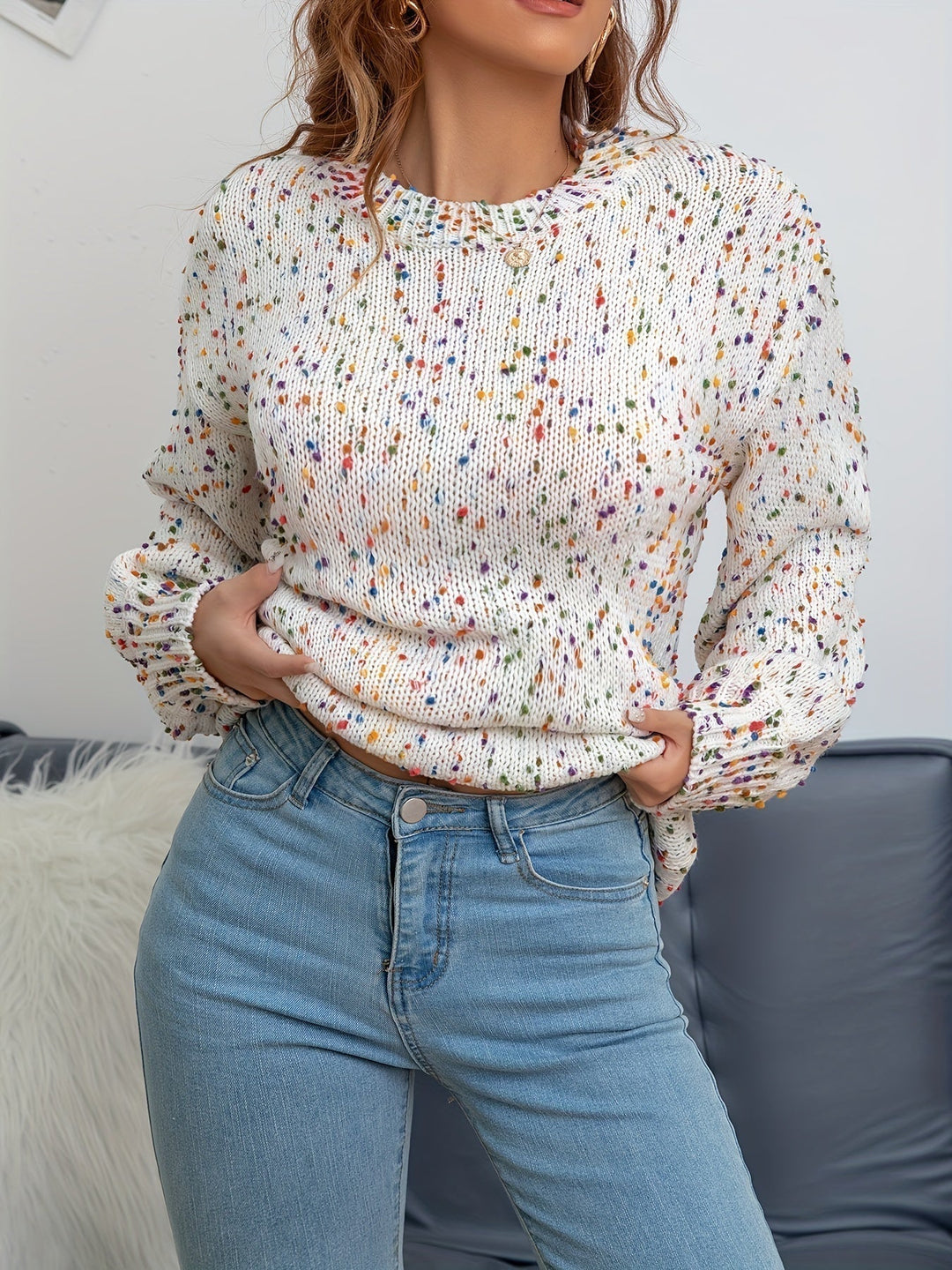 Close-up of confetti specks on women's knit round neck sweater, highlighting the soft acrylic wool texture.