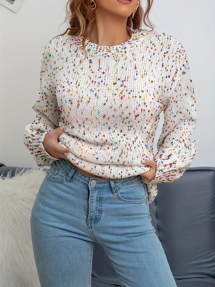 Close-up of confetti specks on women's knit round neck sweater, highlighting the soft acrylic wool texture.