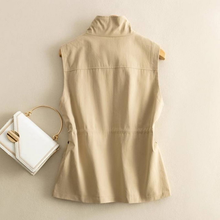Durable women's cotton canvas vest with ample cargo pockets & adjustable drawcord waist for practical utility.