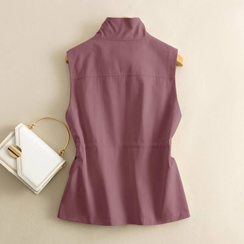 Rugged women's cotton canvas vest with an adjustable waist. Durable outerwear perfect for outdoor or casual wear.