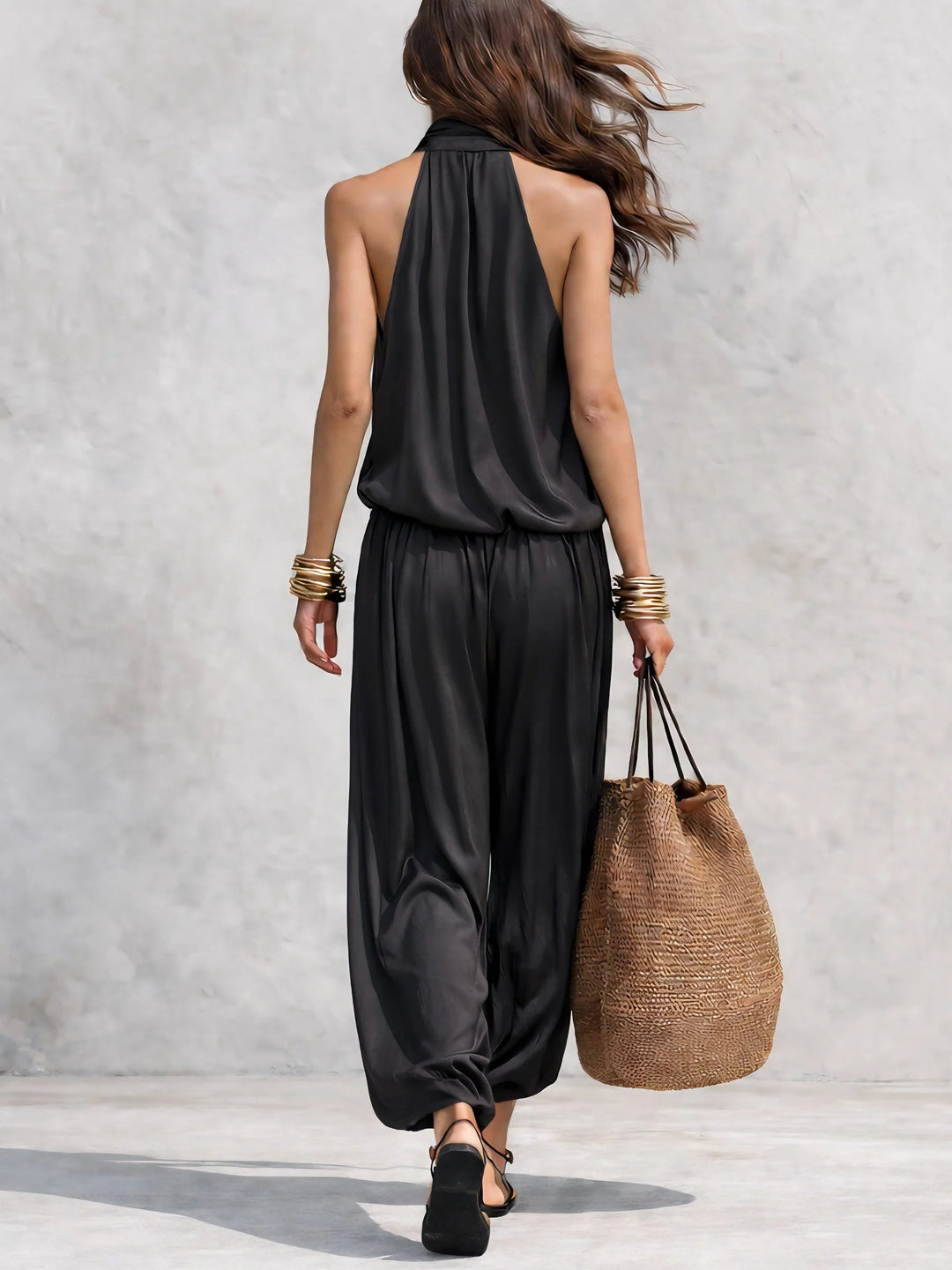 Chic bohemian women's two-piece set with cowl neck halter top and flowy wide leg pants. Ideal for summer fashion.