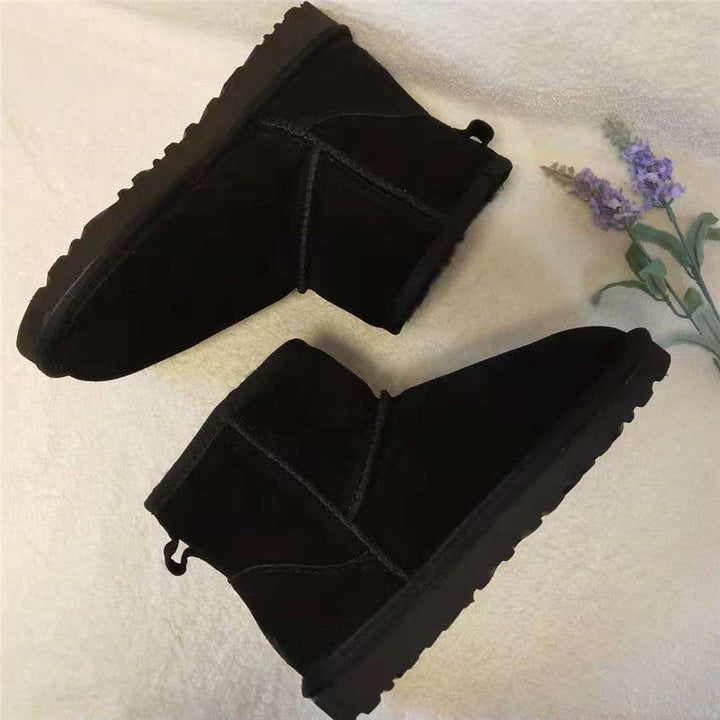Beige women's ankle-high leather snow boots. Cozy, stylish & warm for winter fashion.