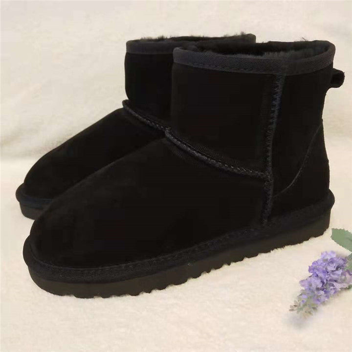 Black women's ankle snow boots, perfect for cold weather comfort. Durable leather winter fashion.