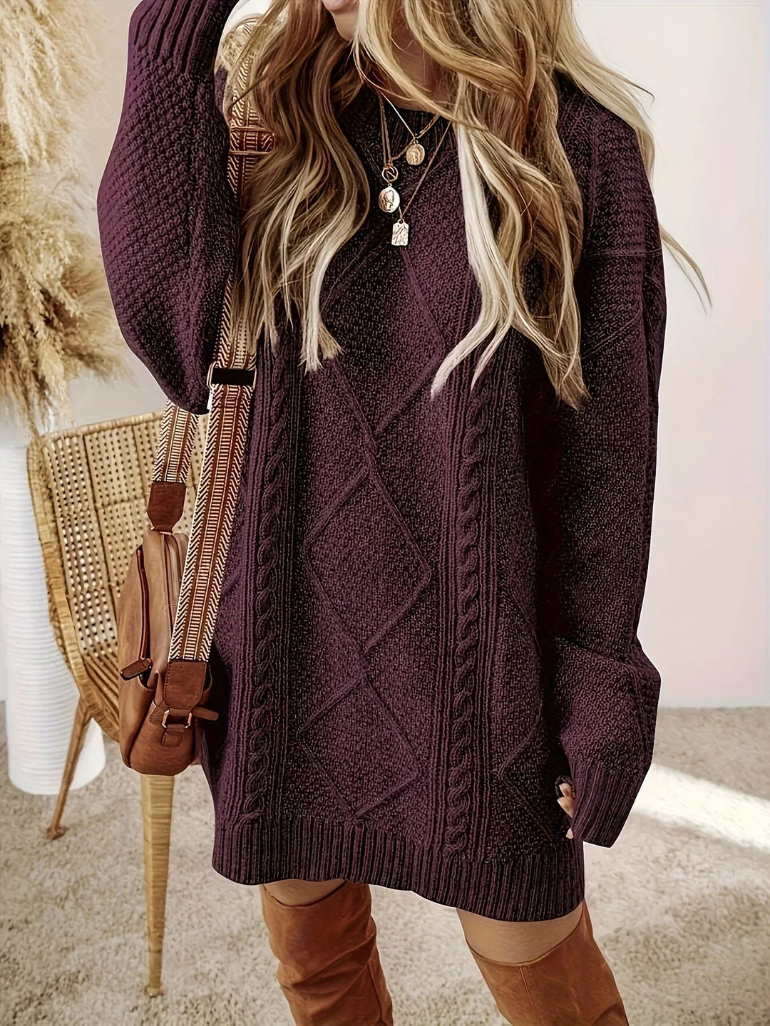 Versatile women's oversized knit dress with elegant cable knit texture for any occasion.