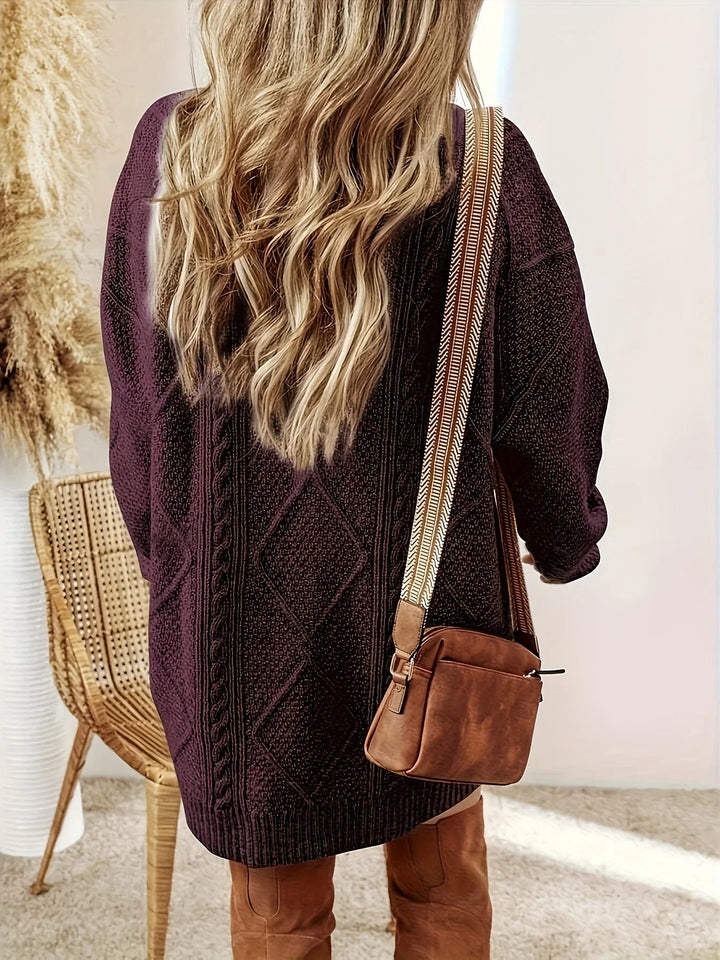 Fashionable women's oversized cable knit sweater dress, ideal for cozy fall outfits.