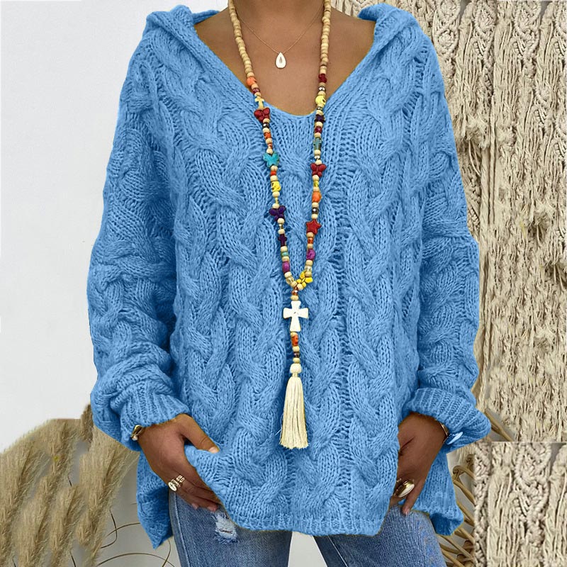 Elegant women's relaxed fit cable knit sweater, versatile for stylish winter fashion.