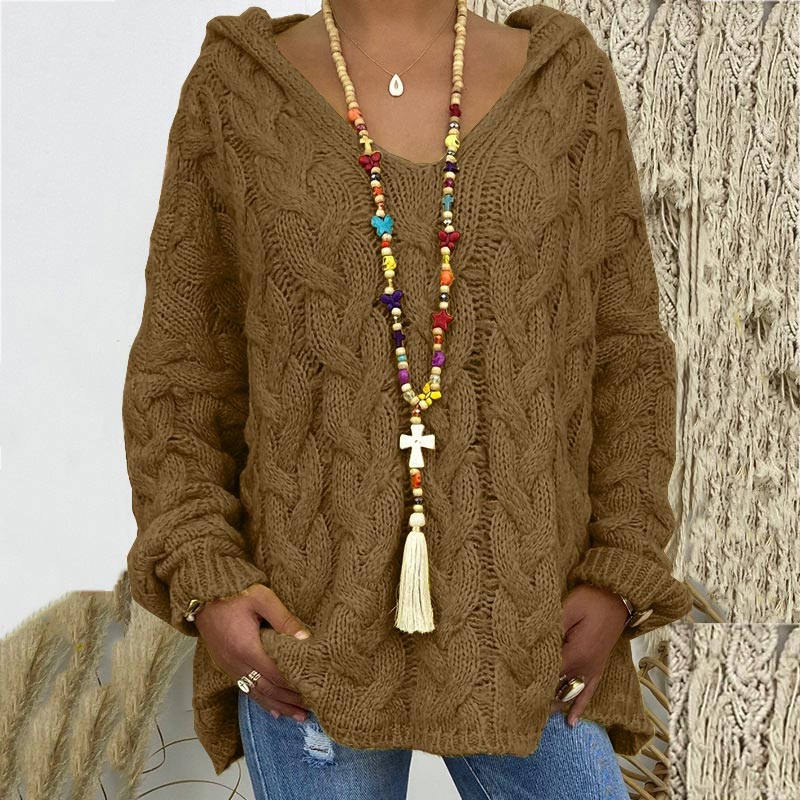 Classic cable knit pattern on a warm women's pullover, embodying timeless and charming style.