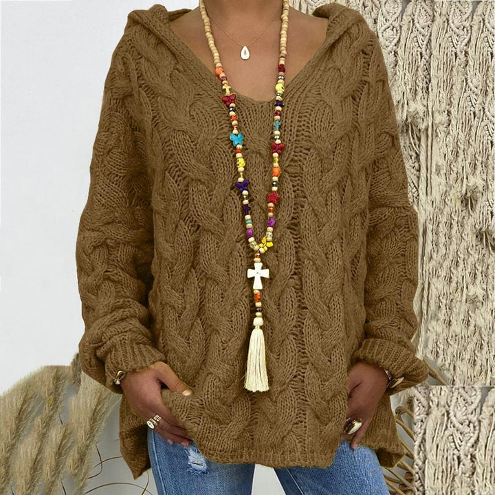 Classic cable knit pattern on a warm women's pullover, embodying timeless and charming style.